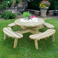 Circular wooden picnic table with four curved benches on grass, natural finish, by Forest Garden, 6'x6' size.