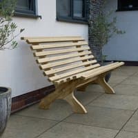 Curved wooden garden bench with slatted backrest and seat, natural finish, on a patio near a white wall and potted plants.