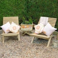 Wooden garden table and chairs set with slatted design, featuring two chairs and a small rectangular table on gravel.