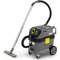 Gray Kärcher vacuum system with yellow accents, black hose, and wheeled base, featuring a sturdy handle and control panel.