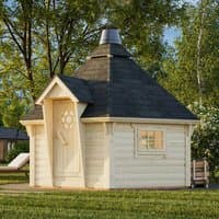 Corner log cabin BBQ hut with hexagonal roof, wooden walls, small window, and chimney, set in a grassy area.