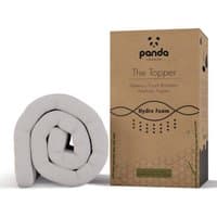 Rolled white Panda memory foam bamboo mattress topper next to branded brown box.
