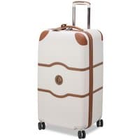 Angora white Delsey suitcase with brown accents, four double wheels, and a retractable handle.