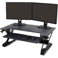 Black Ergotron WorkFit-TL sit-stand desk converter with dual monitor setup, keyboard, and mouse tray.