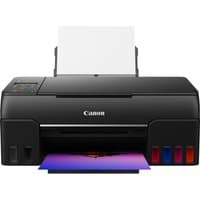 Black Canon PIXMA G650 printer with front ink tanks and rear paper tray, printing a colorful photo.