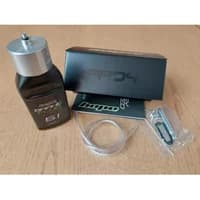 Hope Tech 4 Easy Brake Bleed Kit with black fluid bottle, clear tubing, and small metal tools on a wooden surface.