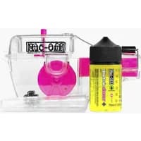 Clear Muc-Off X-3 chain cleaner machine with pink brushes and yellow cleaning fluid bottle.