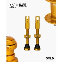 Gold Peatys x Chris King Tubeless MK2 Valves with black rubber bases and crown logo detailing.