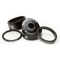 "Black Race Face Headset Spacer Kit with white logos, includes multiple sizes of cylindrical spacers for bike steering."
