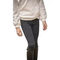 Gray riding pants with mid grip, worn by a girl, paired with a white sweater and black boots.