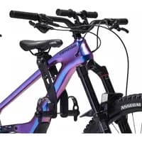 Black Shotgun 2.0 child bike seat and handlebars attached to a purple mountain bike frame.