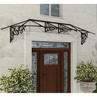 Black Palram Canopia Lily 3100 door canopy with ornate metalwork and clear panels over a wooden door.