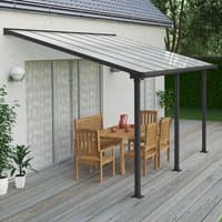 Grey Palram Canopia patio cover with clear panels, supported by dark metal posts, covering a wooden outdoor dining set.