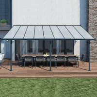 Grey 10x18 Palram Canopia Sierra patio cover with clear panels and dark frame over wooden deck.