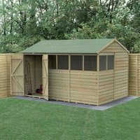 Wooden shed with reverse apex roof, six windows, double doors, natural finish, set on grass with surrounding fence.