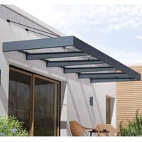 Grey Palram Canopia Sophia XL 5000 door canopy with clear panels and metal support beams over a patio area.