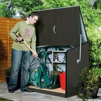 Anthracite metal garden storage shed with hinged lid, vertical paneling, and silver handle, storing garden tools.