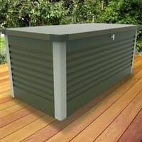 Green metal garden storage box with ribbed sides, silver corners, and a flat lid on a wooden deck.