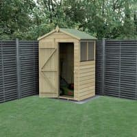 Wooden apex shed with shiplap panels, single door, window, and green roof, set against a gray fence in a garden.