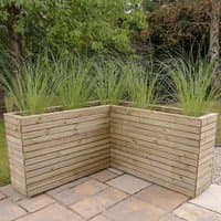 Wooden corner planter with horizontal slats, filled with tall green grasses, measuring 5'3 x 5'3 feet.