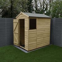 Wooden apex shed with shiplap cladding, single door, and window, set on grass with gray fence backdrop.