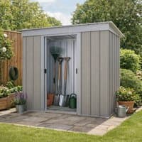 Tall silver metal shed with sliding doors, vertical panel design, and flat roof, set in a garden area.