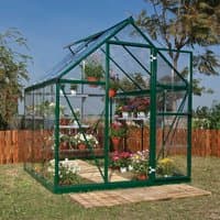 Green polycarbonate greenhouse with triangular roof, clear panels, and metal frame, filled with potted plants.