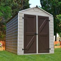 Tan plastic shed with dark brown double doors, skylight roof, and horizontal paneling, set in a grassy yard.