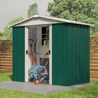 Green metal shed with white trim, double sliding doors, and sloped roof, housing garden tools and hose reel.