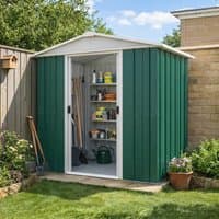 Green metal shed with white trim, double sliding doors open, revealing shelves with tools and garden supplies.