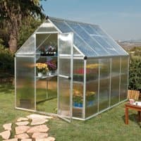Silver Palram Canopia greenhouse with twin-wall polycarbonate panels and a peaked roof, set in a garden.