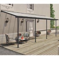 Grey aluminum patio cover with clear roof panels, supported by four posts, over a wooden deck with outdoor furniture.