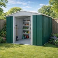 Green metal shed with white trim, double sliding doors, and a pitched roof, set in a garden with shelves inside.
