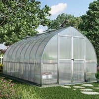 Silver Palram Canopia Bella greenhouse with curved roof, clear panels, and double doors in a garden setting.