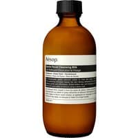 Amber bottle of Aesop Gentle Facial Cleansing Milk with black cap and white label, 200 ml size.