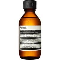 Amber bottle of Aesop In Two Minds Facial Toner, black cap, white label with text, 100 ml size.
