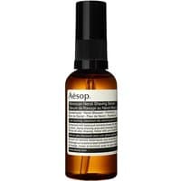 Amber bottle of Aesop Moroccan Neroli Shaving Serum with black pump and white label, 60 ml for sensitive skin.