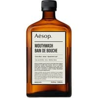Amber glass bottle of Aesop Mouthwash, 500 ml, with black cap and minimalist label design.