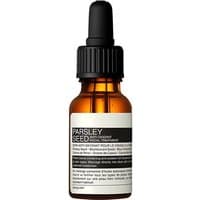 Aesop Parsley Seed Facial Treatment in amber glass bottle with black dropper cap, white label detailing product information.