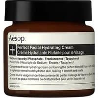 Brown jar of Aesop Perfect Facial Hydrating Cream with black lid and white label detailing ingredients and product name.