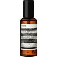 Amber bottle of Aesop Petitgrain Reviving Body Gel, 150 ml, with black cap and white label detailing.