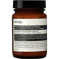 Brown jar of Aesop Primrose Facial Cleansing Masque with black lid and white label detailing product information.