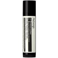 Black and white Aesop lip balm stick with SPF 30 label, 5.5g, sleek design for all skin types.