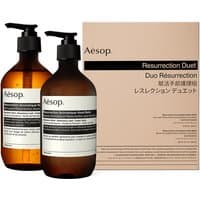 Aesop Resurrection Duet kit with two amber pump bottles, black pumps, and beige box packaging.