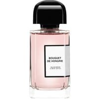 Clear glass bottle with pink liquid, black cap, and white label reading "Bouquet De Hongrie Eau de Parfum."