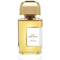 Clear glass bottle of Bdk Oud Abramad Eau de Parfum, gold cap, amber liquid, white label with black text.