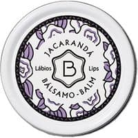White round tin with purple floral design, labeled "Jacaranda Balsamo-Balm" by Benamor, 12 ml moisturizing lip balm.