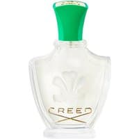 Clear glass bottle of Creed Fleurissimo Eau de Parfum, green cap, embossed logo, gold lettering, 75 ml.