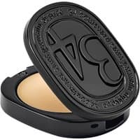 Black oval compact with embossed "34" logo, containing beige solid perfume.