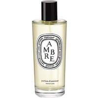 Clear glass bottle with black cap, Diptyque Ambre Room Spray label, amber liquid inside.
